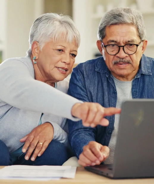 Senior couple using laptop together